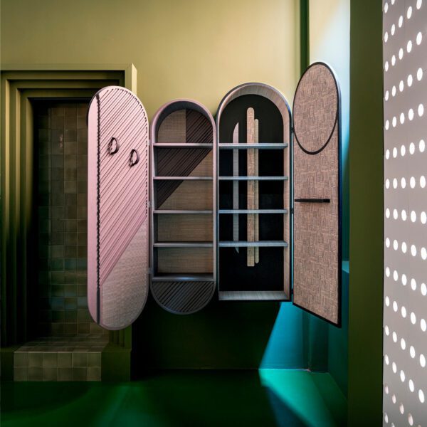 Installation view at Milan Design Week of the wall cabinet with Hermes home decor textiles