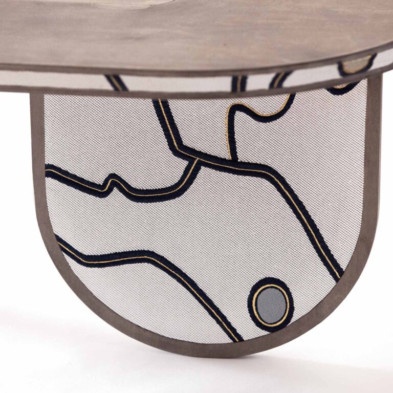 Detail of ultra modern sofa table sourire decorated with Hermes luxury brand Métaphores Paris textile